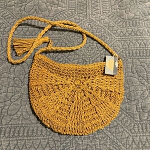 Unchartered Threads straw crescent shaped crossbody bag, tassel detail. NWT